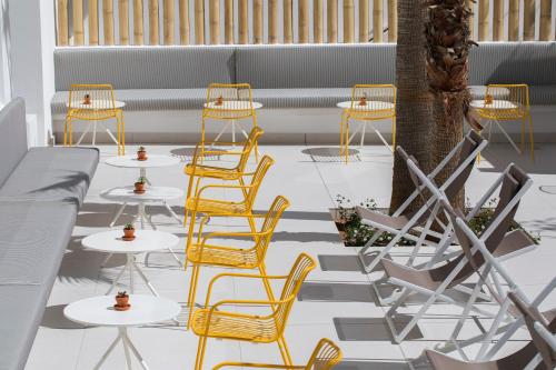 a group of chairs and tables on a patio at whala!fun in El Arenal