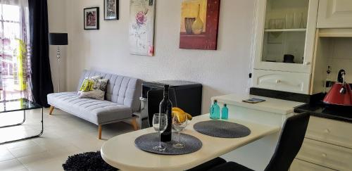 a living room with a table with wine glasses on it at Balcon Del Mar Luxury Suite in Costa Del Silencio