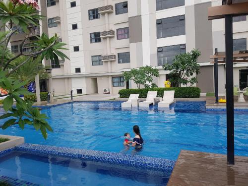 a woman and a child in a swimming pool in a building at KC Studio 5 at Horizon 101 Cebu in Cebu City