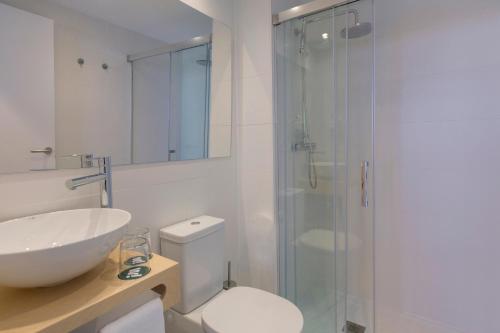 a bathroom with a shower and a toilet and a sink at whala!fun in El Arenal