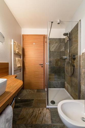 a bathroom with a shower and a sink at Pension Haus Tirol in Laion