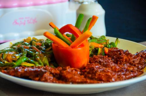 a plate of food with vegetables on a table at Sheratton Regency Hotel in Mombasa