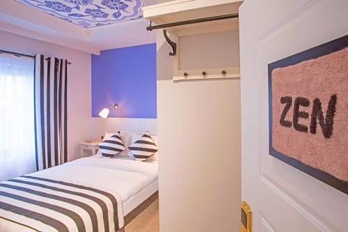 a bedroom with a bed and a wall with purple at Araf Hotel in Konya