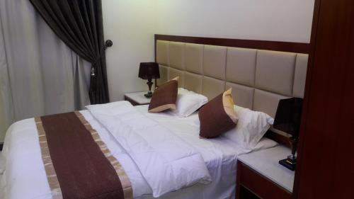 Ένα ή περισσότερα κρεβάτια σε δωμάτιο στο Ashbilia Suites