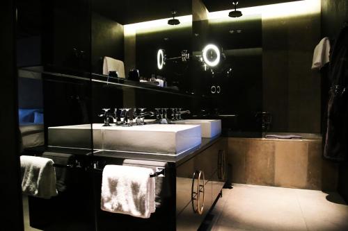 a bathroom with a sink and a large mirror at Hotel Zhero – Ischgl/Kappl in Kappl