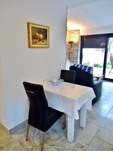 a white table and chairs in a living room at Villa Ana in Savudrija