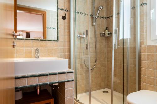 a bathroom with a sink and a shower at BaseCamp Apartments in Zermatt