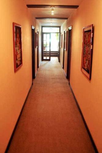 a hallway with orange walls and a long hallway at Hotel Europa in Ostende