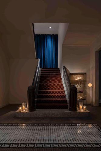 a staircase with a blue curtain in a building at UNWIND HOTEL & BAR OTARU in Otaru