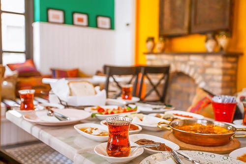 a table with plates and bowls of food on it at Araf Hotel in Konya