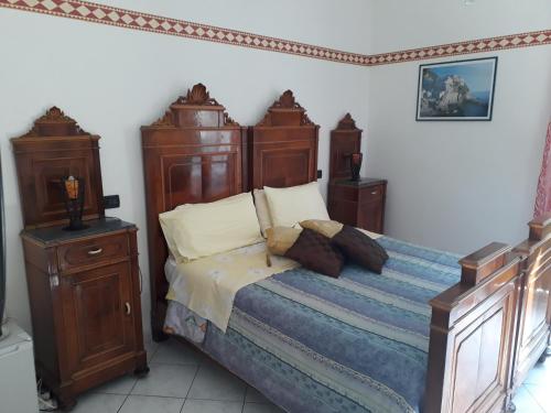 a bedroom with a large bed with wooden furniture at Ca' de Capun in Manarola
