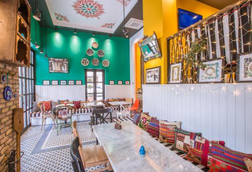 a restaurant with colorful walls and tables and chairs at Araf Hotel in Konya