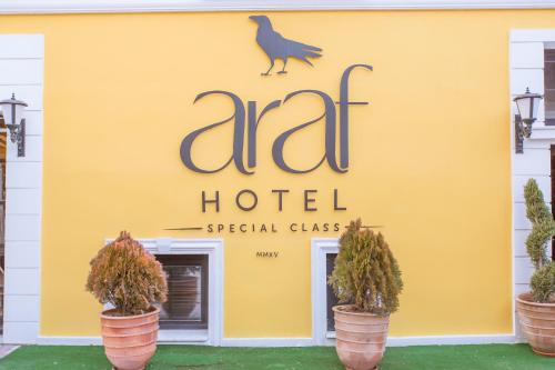 a hotel sign on the side of a yellow building at Araf Hotel in Konya