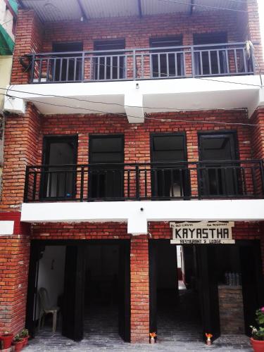 a red brick building with a sign on it at kayastha restaurant & lodge in Bandīpur