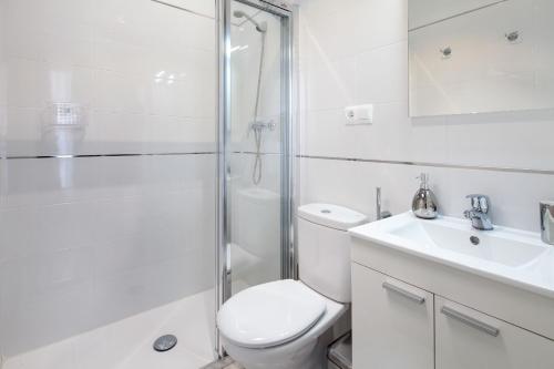a bathroom with a toilet and a shower and a sink at Wanderlust Malaga Apartamentos - Atico in Málaga