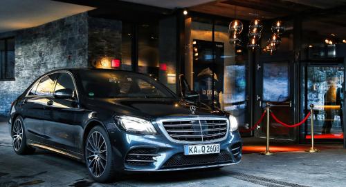 a black car parked in front of a building at Hotel Zhero – Ischgl/Kappl in Kappl