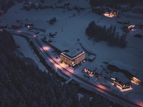a lit up building in the snow at night at Hotel Zhero – Ischgl/Kappl in Kappl
