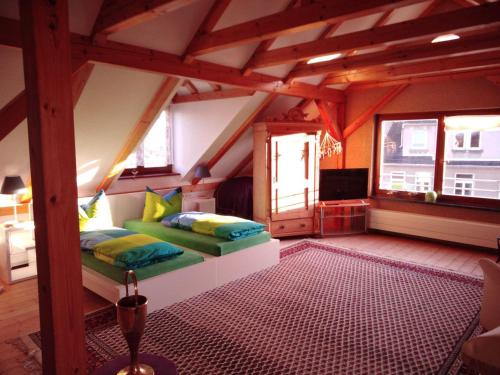 a bedroom with two beds in a attic at FEWO Rotschau im Vogtland in Reichenbach im Vogtland