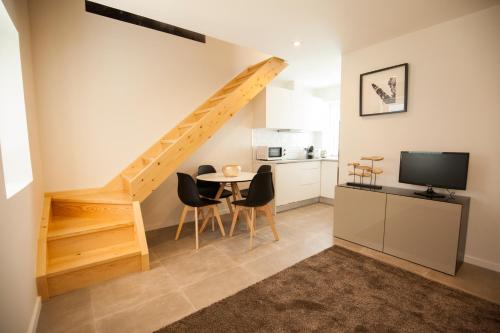 a kitchen and dining room with a table and a staircase at OportoWaves in Matosinhos