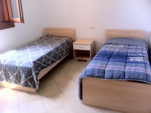 Ένα ή περισσότερα κρεβάτια σε δωμάτιο στο Luna Case Vacanza