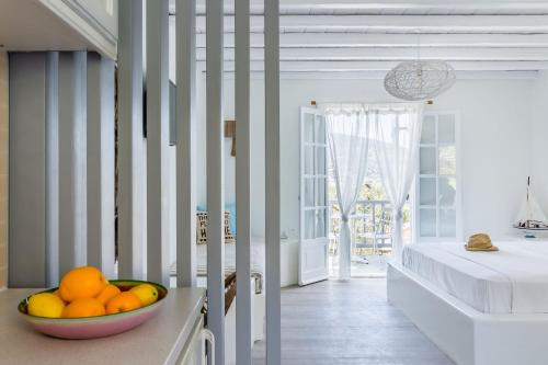 a bowl of fruit on a counter in a bedroom at Evlalia Studios & Villas in Skopelos Town