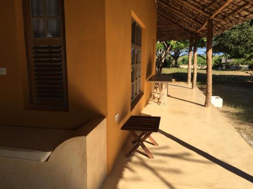 a building with a bench on the side of it at Mangrove House in Lamu