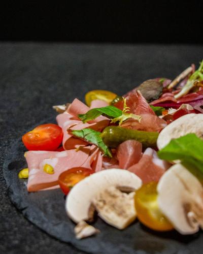 a plate of food with meat and vegetables on it at Le Safari Hotel Restaurant in Carpentras