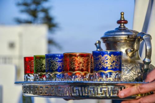 a tray with cups and a tea pot on it at Riad Dari in Tetouan