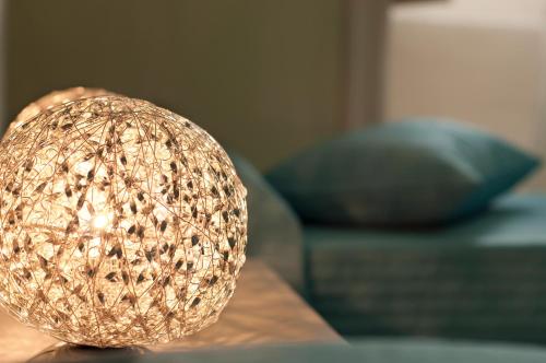 a lamp sitting on a table next to a couch at B&B Villa Roma in Piazza Armerina