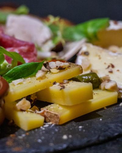 a close up of a plate of food with cheese and vegetables at Le Safari Hotel Restaurant in Carpentras