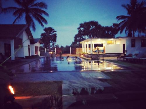 a swimming pool in the middle of a house at Bella Nilaveli Beach in Nilaveli