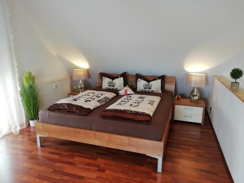 a bed in a room with two pillows on it at Ferienwohnung Prestige 1 in Friedrichshafen
