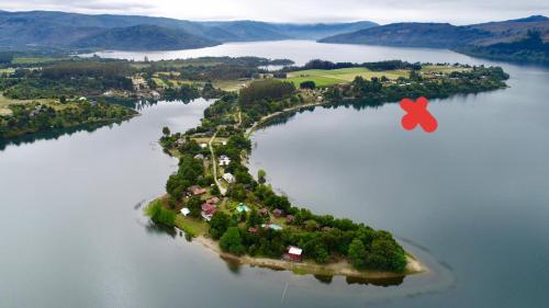 an island in the middle of a large body of water at Complejo Pehuen Lago Lanalhue in Cañete