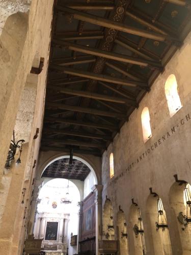 a large building with a wooden ceiling and windows at Paradiso fronte Mare in Agnone Bagni