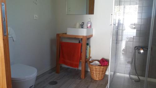 a bathroom with a sink and a toilet and a shower at Our relaxing holiday home in Mosteiros