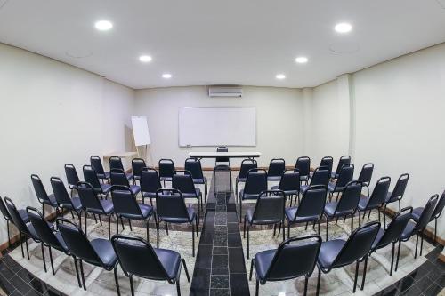 a conference room with chairs and a whiteboard at Hotel Express Rodoviária in Porto Alegre