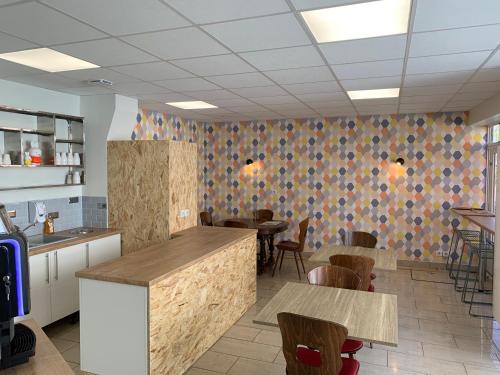 a restaurant with tables and chairs in a room at Logis Hôtel Restaurant Lanex Amboise in Amboise