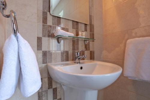 a bathroom with a sink and a white towel at Seaview Heights in Dingle