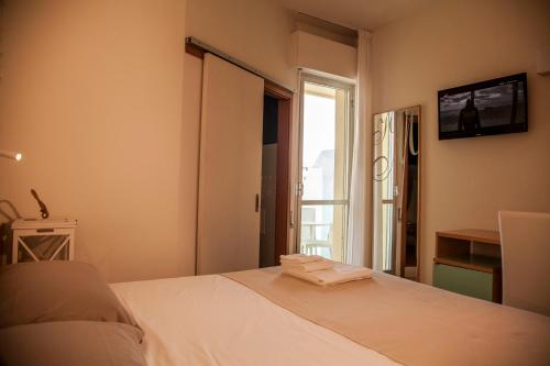 Postel nebo postele na pokoji v ubytování Hotel Montecarlo - Vista Mare con Area Fitness