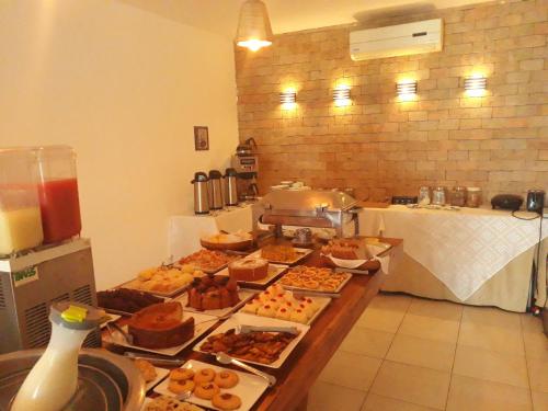 a large table with many plates of food on it at Villa da Praia Hotel in Salvador