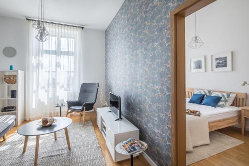 a small living room with a bed and a table at Millennium Suite in Balatonfüred