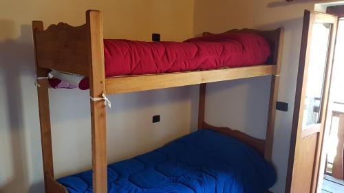 two bunk beds in a room with a red pillow at Agriturismo Volpe Golosa in Morbegno