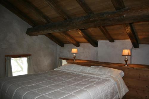 a bedroom with a bed with two lamps on it at Villa San Liberale - Suites & Wellness - Villa Veneta in Feltre