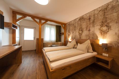 a bedroom with a large bed in a room at ARKADENHOF zur Puszta GRAF in Illmitz