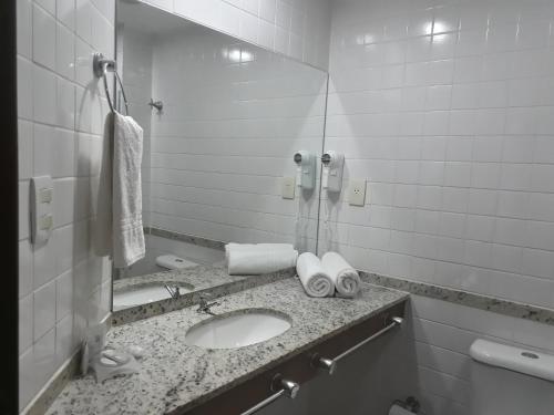 a bathroom with a sink, toilet and shower stall at Villa da Praia Hotel in Salvador