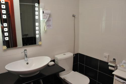 a bathroom with a white toilet and a sink at Apartments Biser in Vrnjačka Banja