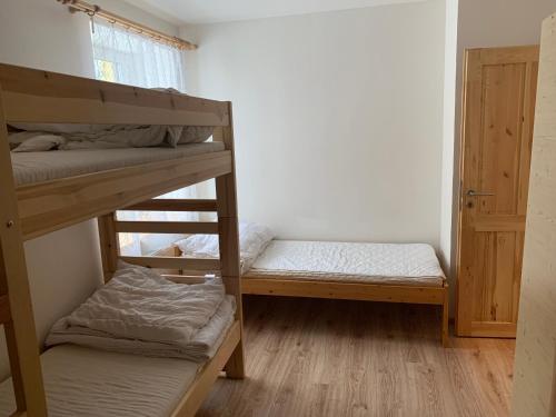 two bunk beds in a room with a window at Chata Stará Škola in Staré Město