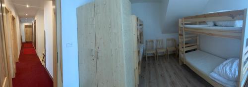 a room with two bunk beds and a hallway at Chata Stará Škola in Staré Město