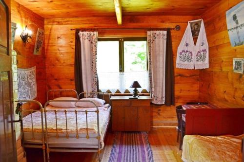 a bedroom with a bed and a window in a cabin at Agroturystyka INKA in Hajnówka