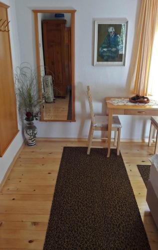 a room with a table and a chair and a mirror at PR`Cajhn in Radovljica